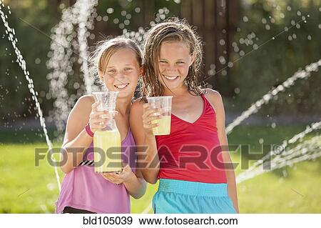 Stock Photo - Caucasian girls drinking lemonade. Fotosearch