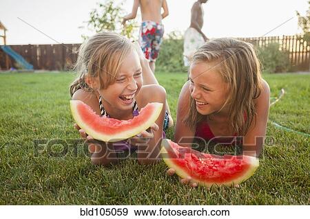 Caucasian girls eating watermelon View Large Photo Image Stock Photo - Caucasian girls eating watermelon. Fotosearch
