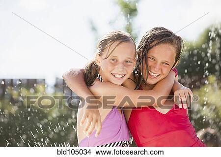 Picture - Caucasian girls playing in water. Fotosearch