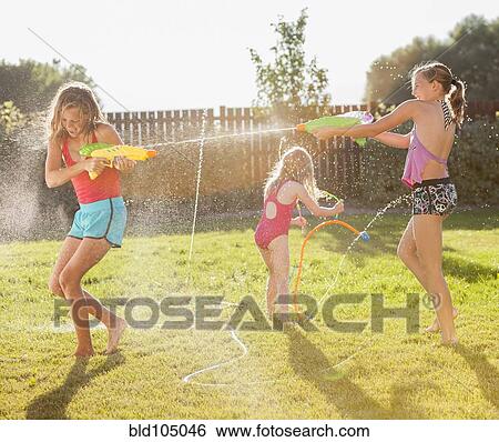Caucasian girls shooting water guns View Large Photo Image Stock Photograph - Caucasian girls shooting water guns. Fotosearch