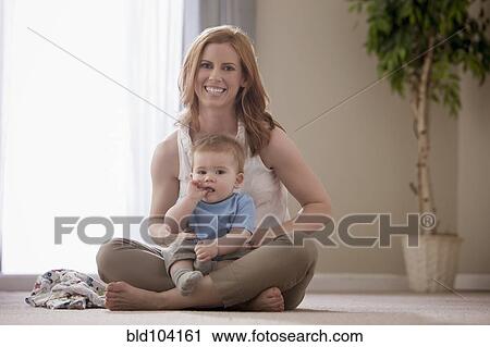 Caucasian mother holding son on lap View Large Photo Image Stock Image - Caucasian mother holding son on lap. Fotosearch