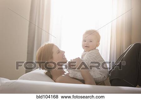 Stock Photo - Caucasian mother playing with son. Fotosearch