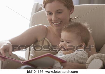 Stock Photograph - Caucasian mother reading book to son. Fotosearch