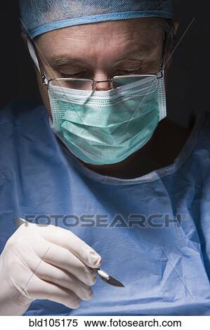 Caucasian surgeon performing surgery View Large Photo Image Stock Photography - Caucasian surgeon performing surgery. Fotosearch