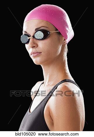 Stock Image - Caucasian swimmer in swim cap and goggles. Fotosearch