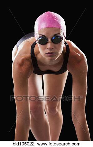 Stock Image - Caucasian swimmer in swim cap and goggles. Fotosearch