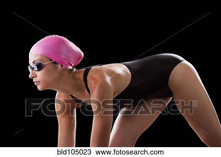 Stock Image - Caucasian swimmer in swim cap and goggles. Fotosearch