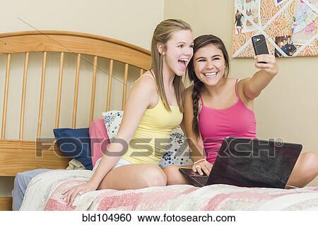 Caucasian teenage girls taking self-portrait with cell phone View Large Photo Image Stock Image - Caucasian teenage girls taking self-portrait with cell phone. Fotosearch