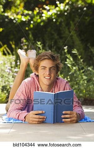 Caucasian teenager reading outdoors View Large Photo Image Picture - Caucasian teenager reading outdoors. Fotosearch