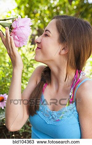 Caucasian teenager smelling flower View Large Photo Image Stock Image - Caucasian teenager smelling flower. Fotosearch