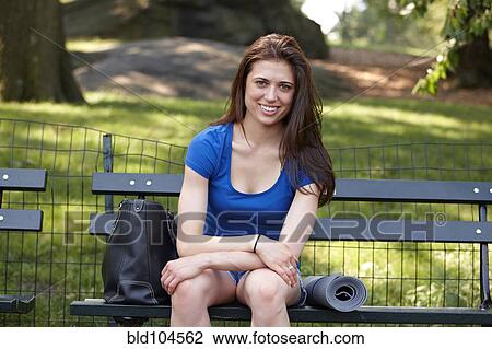 Caucasian woman sitting on park bench View Large Photo Image Stock Image - Caucasian woman sitting on park bench. Fotosearch