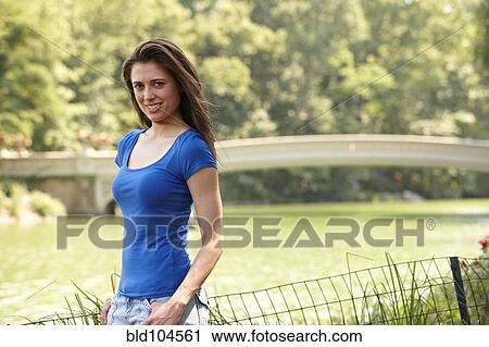 Stock Image - Caucasian woman standing near river. Fotosearch