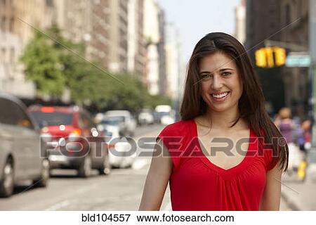 Caucasian woman standing on city street View Large Photo Image Stock Photo - Caucasian woman standing on city street. Fotosearch