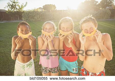 Stock Photography - Children eating cantaloupe. Fotosearch