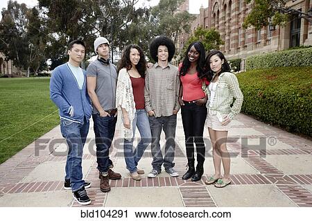 Stock Image - College students standing on campus walkway. Fotosearch