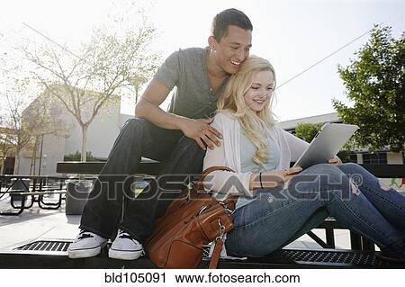 Stock Image - Couple looking at digital tablet. Fotosearch