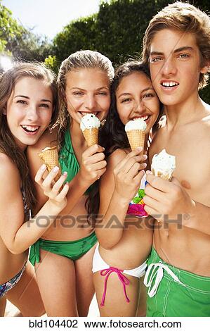 Stock Image - Friends eating ice cream cones. Fotosearch