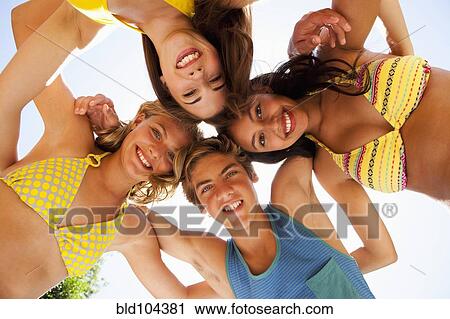 Stock Image - Friends hugging in circle. Fotosearch