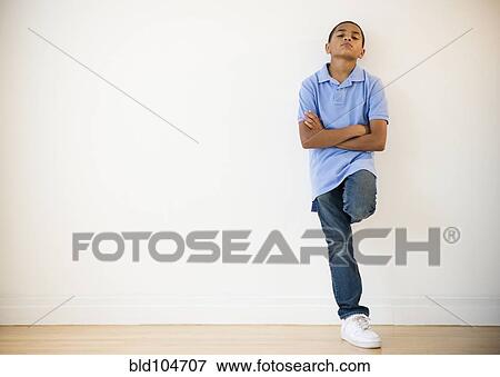 Frustrated Hispanic boy leaning against wall View Large Photo Image Stock Photo - Frustrated Hispanic boy leaning against wall. Fotosearch