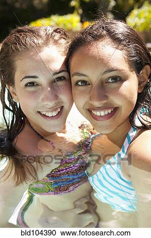 Girls enjoying swimming pool together View Large Photo Image Stock Image - Girls enjoying swimming pool together. Fotosearch