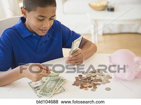 Stock Photo - Hispanic boy counting money. Fotosearch