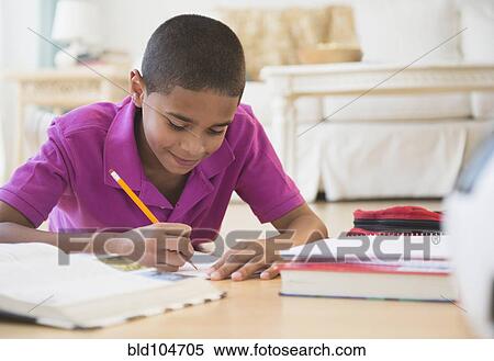Stock Photography - Hispanic boy doing homework. Fotosearch