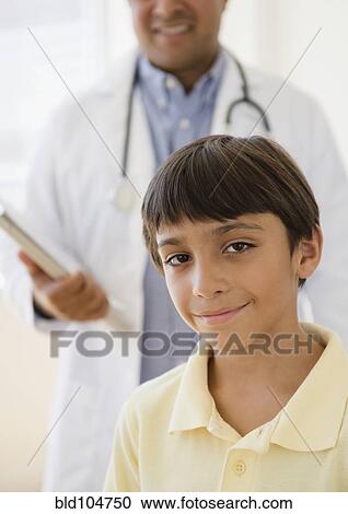 Stock Image - Hispanic boy in doctor's office. Fotosearch
