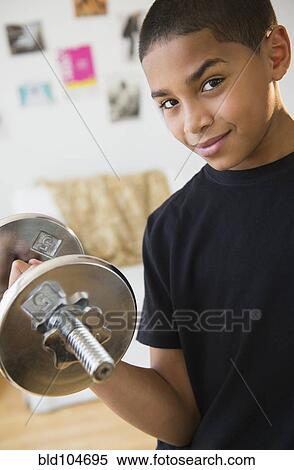 Hispanic boy lifting weights View Large Photo Image Stock Photography - Hispanic boy lifting weights. Fotosearch