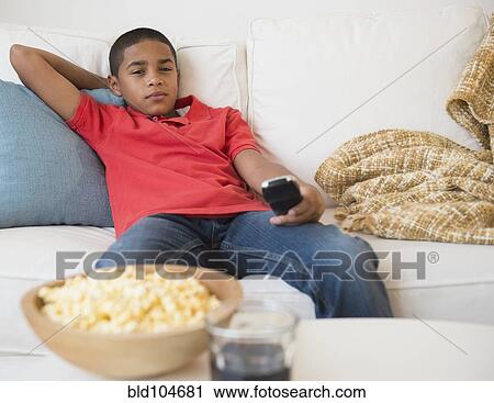 Stock Image - Hispanic boy watching television. Fotosearch