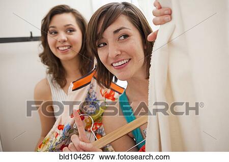 Hispanic friends shopping in clothing store View Large Photo Image Stock Photo - Hispanic friends shopping in clothing store. Fotosearch