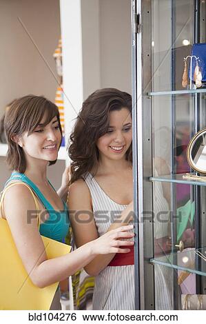Hispanic friends shopping in store View Large Photo Image Stock Photograph - Hispanic friends shopping in store. Fotosearch