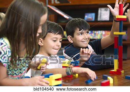 Hispanic students in library playing with blocks View Large Photo Image Stock Image - Hispanic students in library playing with blocks. Fotosearch