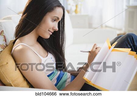 Stock Photograph - Hispanic teenager doing homework. Fotosearch