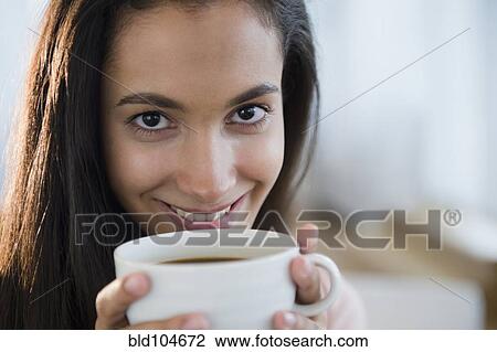 Stock Image - Hispanic teenager drinking coffee. Fotosearch
