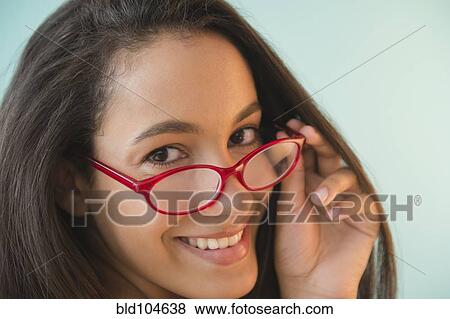 Stock Photo - Hispanic teenager in red eyeglasses. Fotosearch