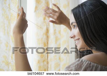 Stock Photo - Hispanic teenager looking out window. Fotosearch