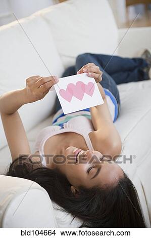 Picture - Hispanic teenager reading Valentine's Day card. Fotosearch