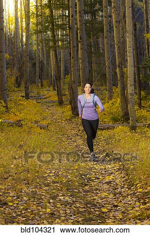 Hispanic woman running in woods View Large Photo Image Stock Image - Hispanic woman running in woods. Fotosearch