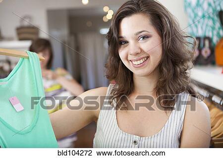 Hispanic woman shopping in clothing store View Large Photo Image Stock Image - Hispanic woman shopping in clothing store. Fotosearch