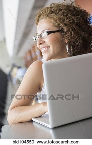 Hispanic woman using laptop View Large Photo Image Stock Image - Hispanic woman using laptop. Fotosearch