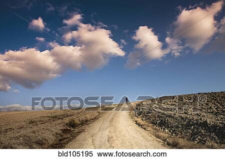 Man walking on dirt road View Large Photo Image Stock Photography - Man walking on dirt road. Fotosearch