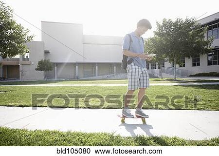 Mixed race boy on skateboard View Large Photo Image Stock Image - Mixed race boy on skateboard. Fotosearch