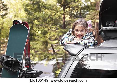 Stock Photo - Mixed race girl on top of car. Fotosearch