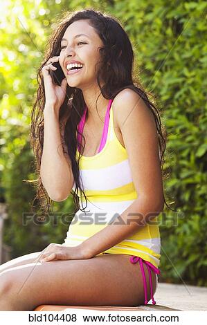 Stock Photo - Mixed race girl talking on cell phone. Fotosearch