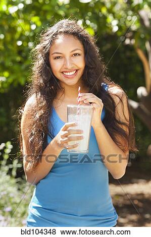 Stock Photo - Mixed race woman drinking lemonade outdoors. Fotosearch
