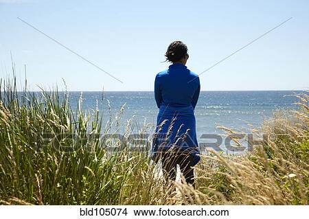 Mixed race woman looking at ocean View Large Photo Image Picture - Mixed race woman looking at ocean. Fotosearch