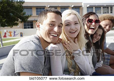 Stock Photo - School friends hanging out together. Fotosearch