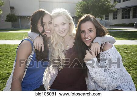 Stock Image - School friends hugging. Fotosearch