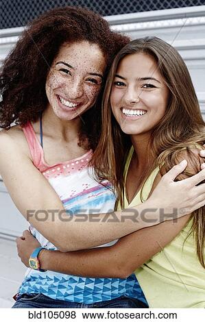 Stock Photo - School friends sitting together on bleachers. Fotosearch