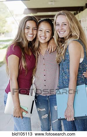 Stock Image - School friends standing in portico. Fotosearch
